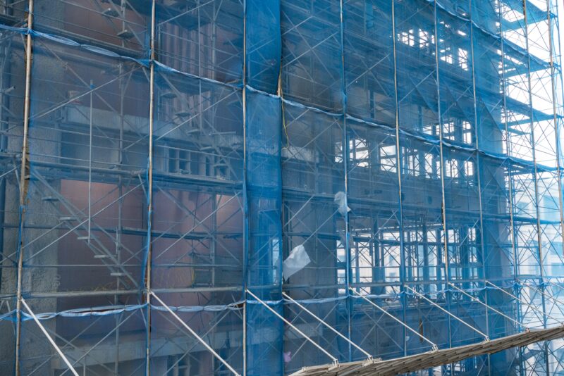 Tall,Building,With,Blue,Wall,Safety,Net